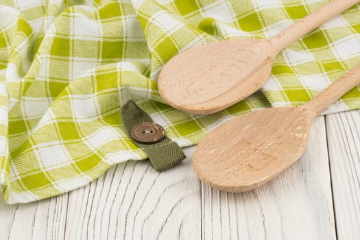 Wooden spoons on old white wooden table. Selective focus.