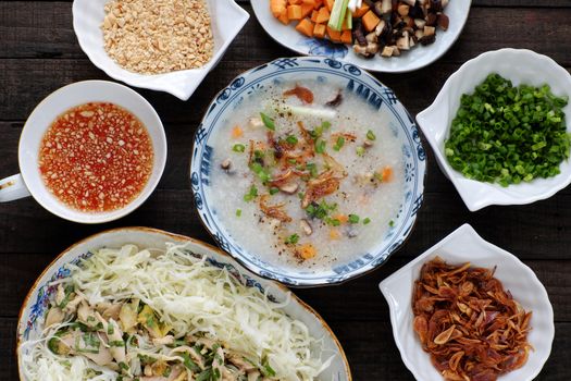 Asian food for sick people, chicken rice gruel with raw material as chicken, rice, carrot, onion, agaric, cabbage. Bowl of chicken porridge with fixed vegetable, also call chao ga