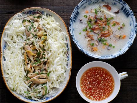 Asian food for sick people, chicken rice gruel with raw material as chicken, rice, carrot, onion, agaric, cabbage. Bowl of chicken porridge with fixed vegetable, also call chao ga