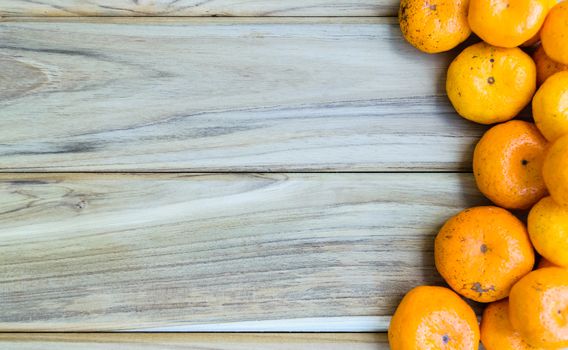 Fresh oranges on wooden background