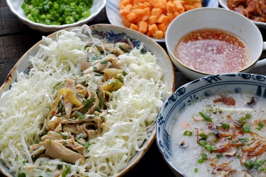 Asian food for sick people, chicken rice gruel with raw material as chicken, rice, carrot, onion, agaric, cabbage. Bowl of chicken porridge with fixed vegetable, also call chao ga