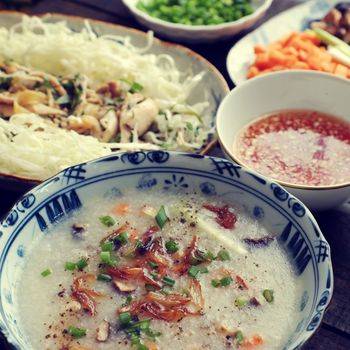 Asian food for sick people, chicken rice gruel with raw material as chicken, rice, carrot, onion, agaric, cabbage. Bowl of chicken porridge with fixed vegetable, also call chao ga