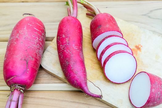 Red radish on wooden table