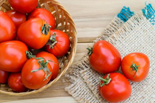 raw tomatoes on wooden table