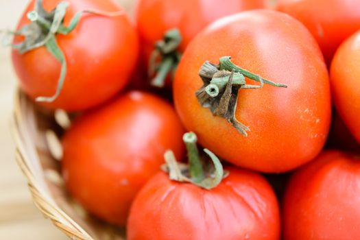 raw tomatoes on wooden table