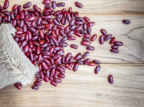 Dried red beans on a sack on wooden table