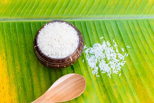 rice in coconut shell on banana leaf