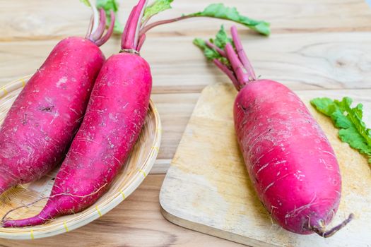 Red radish on wooden table