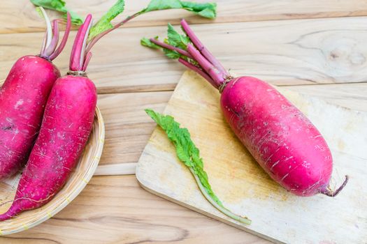 Red radish on wooden table