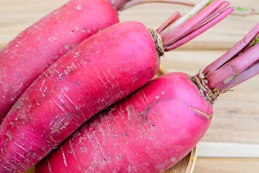 Red radish on wooden table