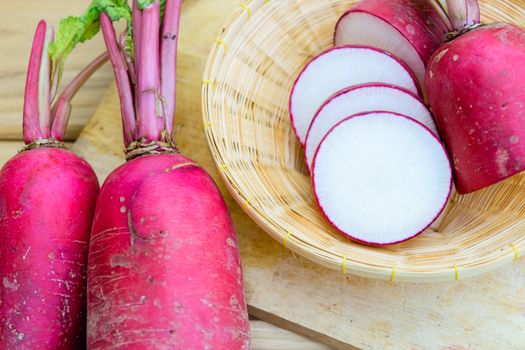 Red radish on wooden table