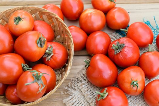 raw tomatoes on wooden table