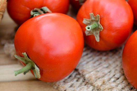 raw tomatoes on wooden table