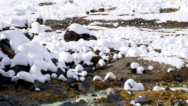 Closeup stone and snow in the mist Noboribetsu onsen snow winter national park in Jigokudani, Hokkaido, Japan    