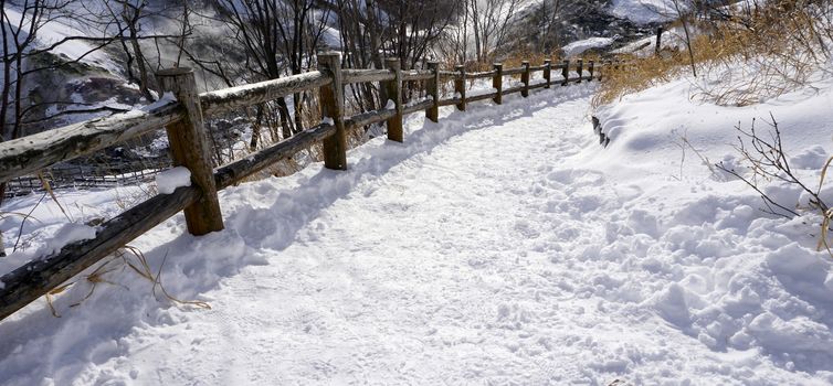 Snow and curved walkway in the forest Noboribetsu onsen snow winter national park in Jigokudani, Hokkaido, Japan