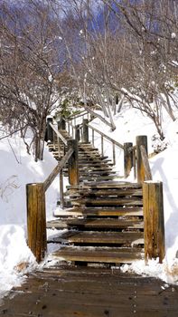 Snow stair walkway and railing in the forest Noboribetsu onsen snow winter national park in Jigokudani, Hokkaido, Japan