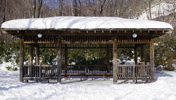 Snow and wooden pavilion elevation in the forest Noboribetsu onsen snow winter national park in Jigokudani, Hokkaido, Japan