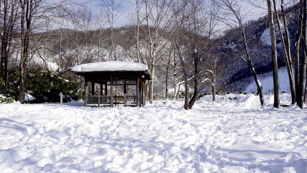 Snow and wooden pavilion landscape in the forest Noboribetsu onsen snow winter national park in Jigokudani, Hokkaido, Japan