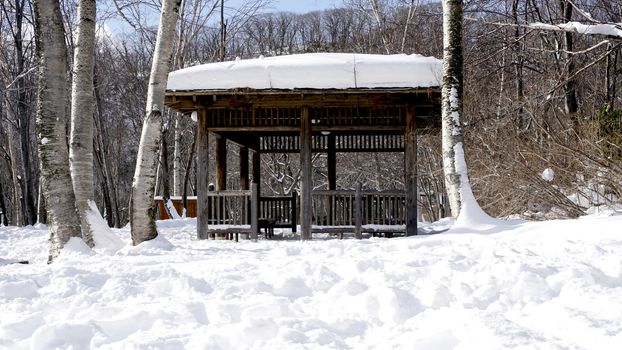 Snow and wooden pavilion landscape in the forest Noboribetsu onsen snow winter national park in Jigokudani, Hokkaido, Japan