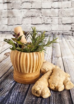 Ginger and herbs on a wooden board