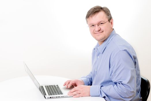 Smiling men working on laptop