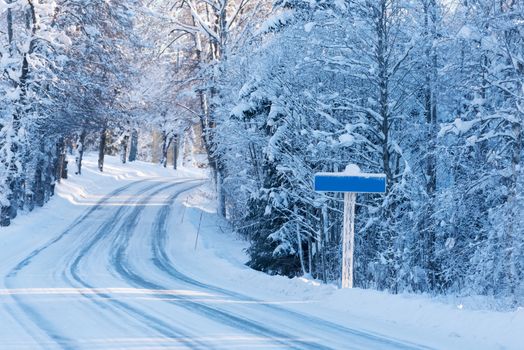 Road sign on winter road, empty