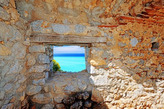View on calm sea through window in stone wall