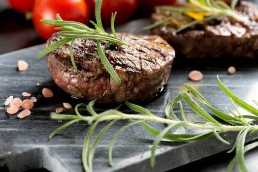 Grilled bbq steak with rosemary and tomatoes.