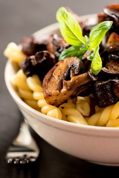 Fusilli with mushrooms, italian cuisine