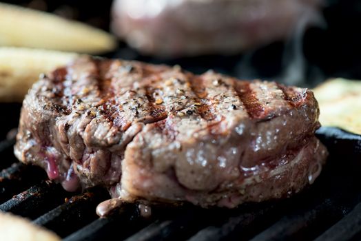 striped steak on a grill closeup