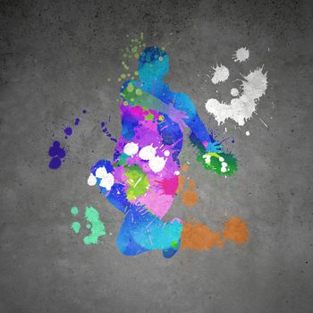 Image with color silhouette of dancer on gray wall