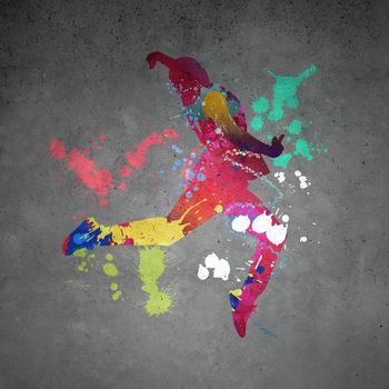 Image with color silhouette of dancer on gray wall