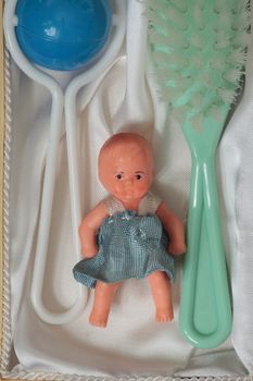 Doll Brush rattle present in the open box top view close to