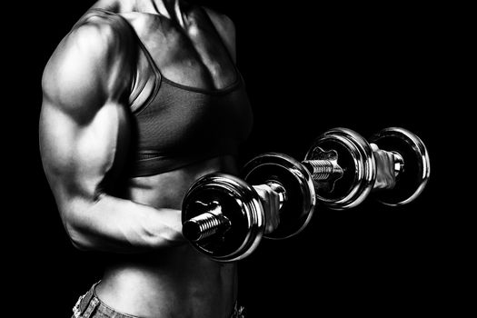 Fit woman with barbells, isolated on black