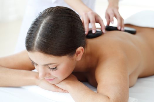 Girl on a stone therapy, hot stone massage