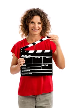 Portrait of a smiling middle aged brunette holding a clapboard