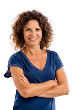 Smiling middle aged woman with arms folded, isolated on white background