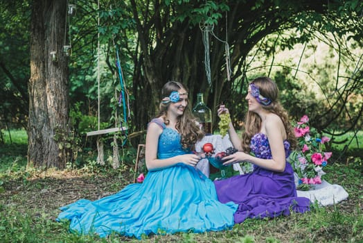 two adult sisters with fruit in the garden