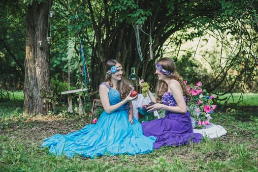 two adult sisters with fruit in the garden