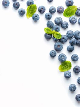 Blueberries isolated on white background. Blueberry border design. Ripe and juicy fresh picked bilberries close up. Copyspace. Top view or flat lay