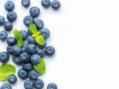 Blueberries isolated on white background. Blueberry border design. Ripe and juicy fresh picked bilberries close up. Copyspace. Top view or flat lay