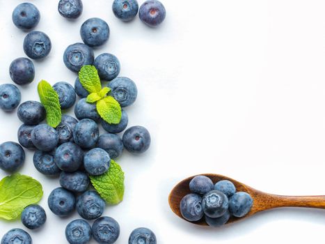 Blueberries isolated on white background. Blueberry border design. Ripe and juicy fresh picked bilberries close up. Copyspace. Top view or flat lay