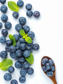 Blueberries isolated on white background. Blueberry border design. Ripe and juicy fresh picked bilberries close up. Copyspace. Top view or flat lay