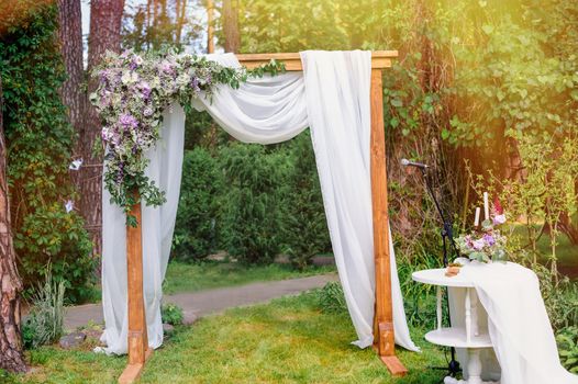 wedding arch in the style of rustic pine summer park.