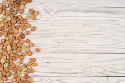 The beans on the old wooden table. Abstract background, empty template. Top view.