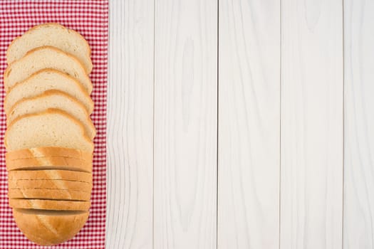 Loaf of bread on a wooden table. Top view.