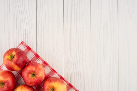 Red apples on the old wooden table. Top view.