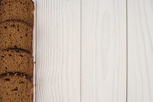 Rye bread on an old white wooden table. Top view.