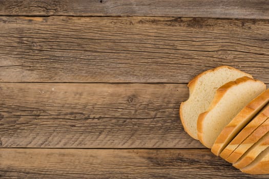 Sliced bread on an old wooden table.top view.