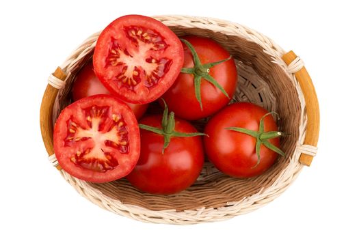 ripe tomatoes in a wicker basket isolated on white background. Top view.